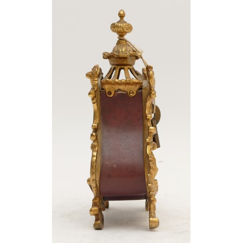 359 - A French 20th century gilt metal and burgundy leather time piece, with ornate mounts, the case numbe... 