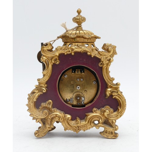 359 - A French 20th century gilt metal and burgundy leather time piece, with ornate mounts, the case numbe... 