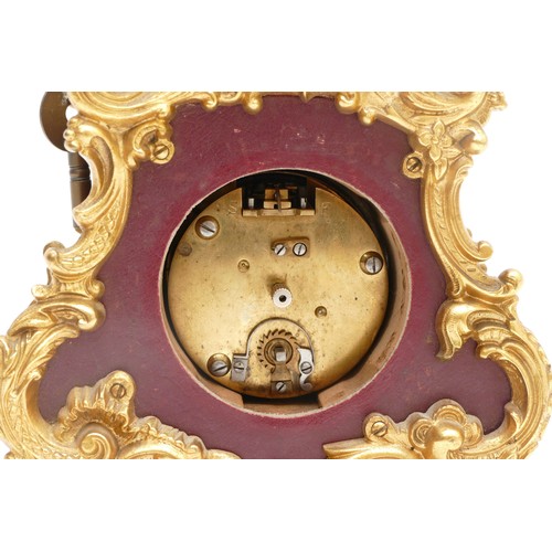 359 - A French 20th century gilt metal and burgundy leather time piece, with ornate mounts, the case numbe... 