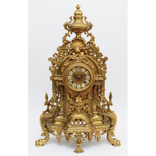 365 - A 20th century large and ornate brass mantel clock, with heavy floral case and vase surmount, the Ge... 