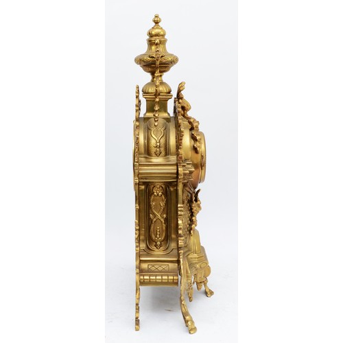 365 - A 20th century large and ornate brass mantel clock, with heavy floral case and vase surmount, the Ge... 