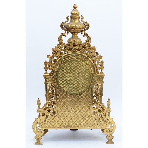 365 - A 20th century large and ornate brass mantel clock, with heavy floral case and vase surmount, the Ge... 