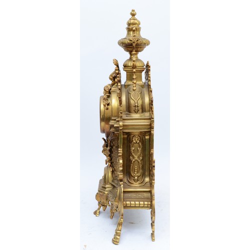 365 - A 20th century large and ornate brass mantel clock, with heavy floral case and vase surmount, the Ge... 