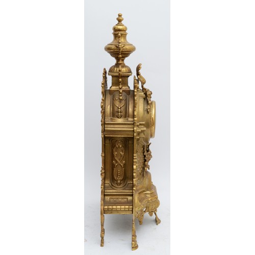 371 - A 20th century large and ornate brass mantel clock, with heavy floral case and vase surmount, the Ge... 