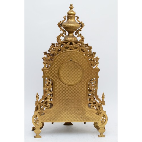 371 - A 20th century large and ornate brass mantel clock, with heavy floral case and vase surmount, the Ge... 