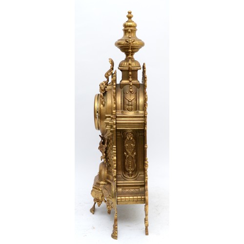 371 - A 20th century large and ornate brass mantel clock, with heavy floral case and vase surmount, the Ge... 