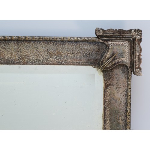 385 - An early 20th century electroplated wall mirror, bevelled edged glass with a hammered finish frame, ... 