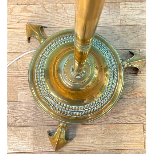 387 - An Edwardian brass rise adjustable standard lamp, with cast iron base, raised on three pad feet, 140... 