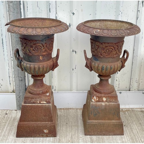 411 - A pair of cast iron campana garden urns, raised on square bases, one with an 18cm section missing, 8... 