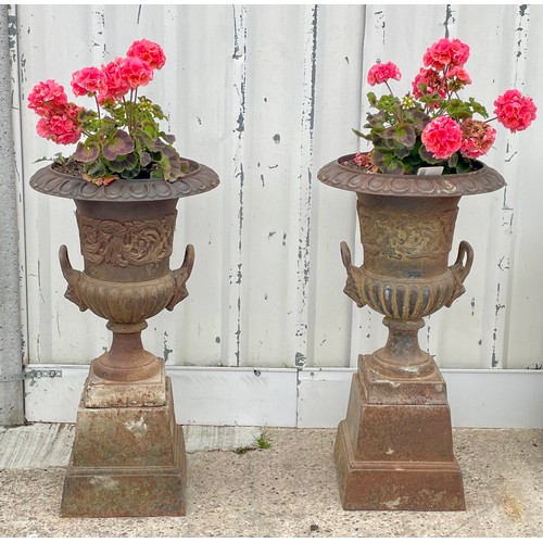 416 - A pair of cast iron campana garden urns, raised on square bases, 87cm