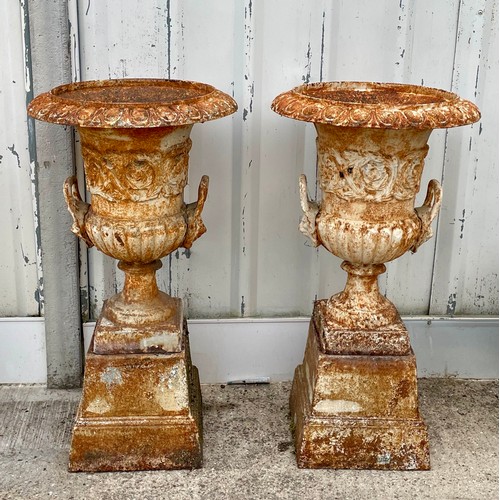 418 - A pair of cast iron campana garden urns, raised on square bases, 87cm