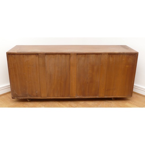 433 - An Ercol blond elm Windsor sideboard, model No. 455, having three central drawers flanked by cupboar... 