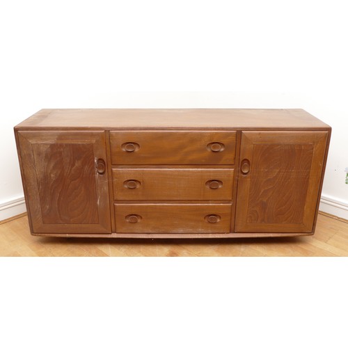 433 - An Ercol blond elm Windsor sideboard, model No. 455, having three central drawers flanked by cupboar... 