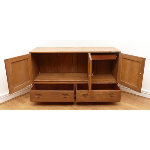 434 - An Ercol blond elm Windsor sideboard, model 429, with a two-door cupboard and adjustable shelf, anot... 