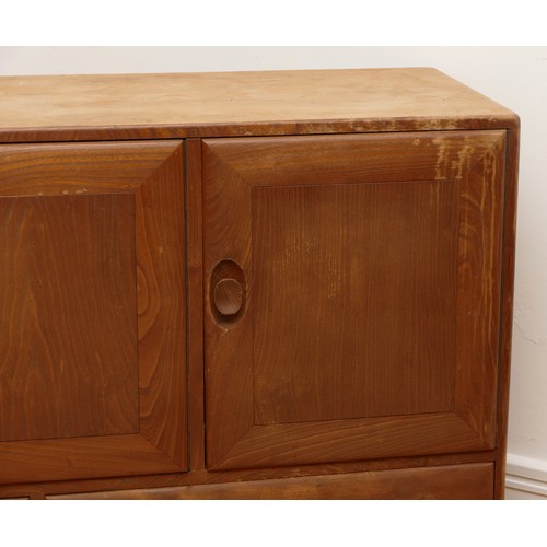 434 - An Ercol blond elm Windsor sideboard, model 429, with a two-door cupboard and adjustable shelf, anot... 