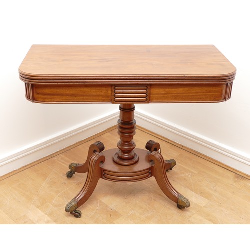 435 - A Victorian mahogany fold over games table, with baize insert, raised on a turned pedestal with quat... 