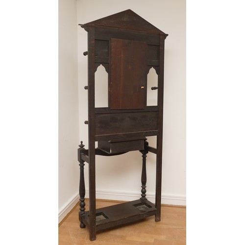 455 - A late 19th century Low Countries oak hall stand, with foliate and mask carvings, central bevelled e... 