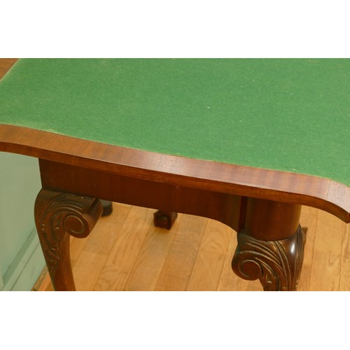 449 - An Edwardian mahogany fold over games table, with baize cover and leaf capped with ball and claw fee... 