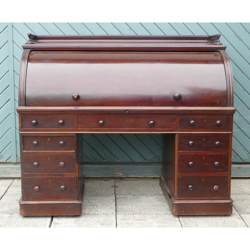 450 - A Victorian mahogany roll top desk, retailed by E. Miller & Co. Ltd., Leeds, with pull out slide rev... 