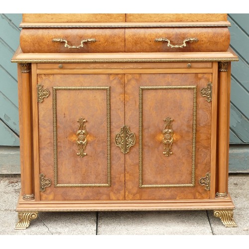 453 - An Italian burr walnut with brass applied mounts drinks cabinet, the cupboard doors opening to revea... 