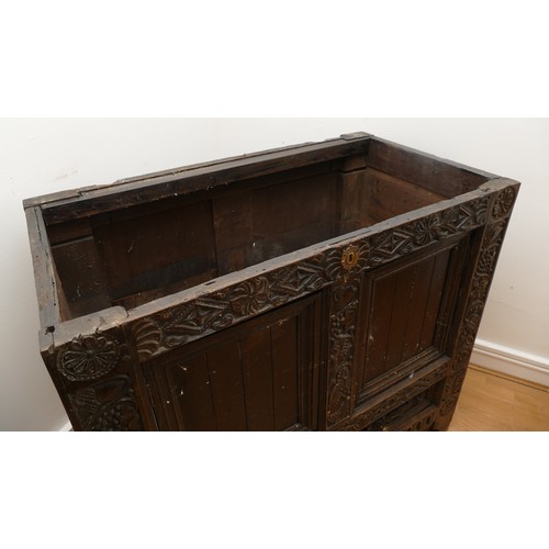 458 - A 17th century and later carved ebonised mule chest, the hinged lid opening to spacious interior, tw... 