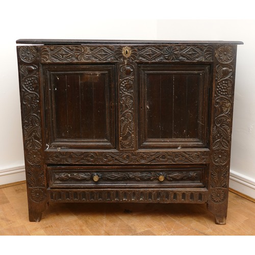 458 - A 17th century and later carved ebonised mule chest, the hinged lid opening to spacious interior, tw... 