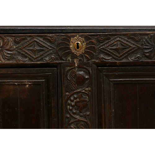 458 - A 17th century and later carved ebonised mule chest, the hinged lid opening to spacious interior, tw... 