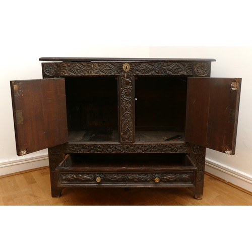 458 - A 17th century and later carved ebonised mule chest, the hinged lid opening to spacious interior, tw... 