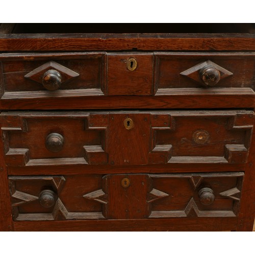 459 - A late 17th century oak chest of drawers, comprising four long graduated drawers (lacking top one) e... 