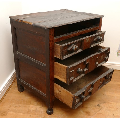 459 - A late 17th century oak chest of drawers, comprising four long graduated drawers (lacking top one) e... 