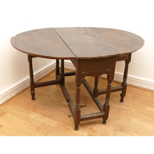 461 - A late 17th early 18th century oak gateleg dining table, the extending top of oval form, raised on t... 