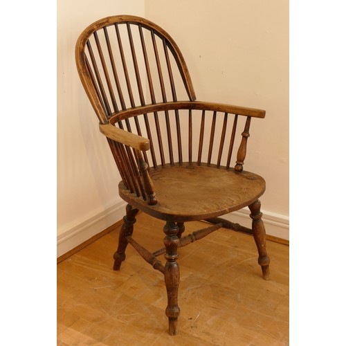 462 - A late 19th century oak and elm windsor chair, having stick and hoop back, outswept armrests support... 