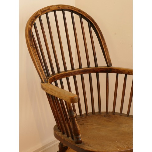 462 - A late 19th century oak and elm windsor chair, having stick and hoop back, outswept armrests support... 