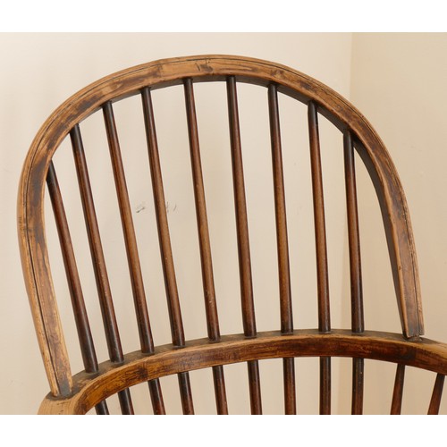 462 - A late 19th century oak and elm windsor chair, having stick and hoop back, outswept armrests support... 