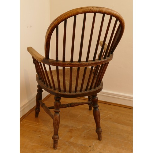 462 - A late 19th century oak and elm windsor chair, having stick and hoop back, outswept armrests support... 