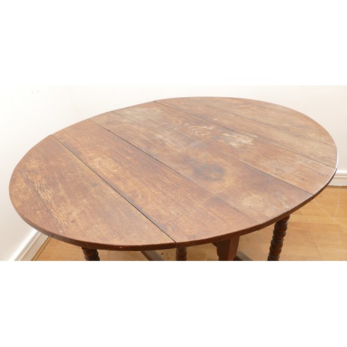 463 - A late 18th century oak gateleg dining table, the extending planked top of oval form, raised on turn... 