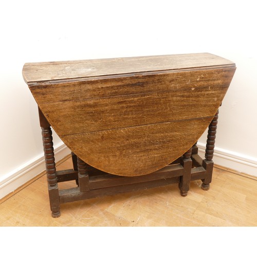 466 - A 19th Century oak gateleg dining table, of oval form on block base with baluster turned supports, 1... 