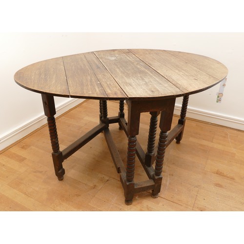 466 - A 19th Century oak gateleg dining table, of oval form on block base with baluster turned supports, 1... 