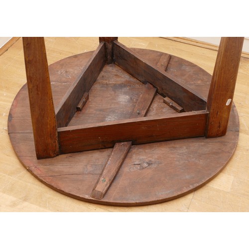 473 - A 19th Century pine cricket table, the circular top on three splayed and moulded square supports, 78... 