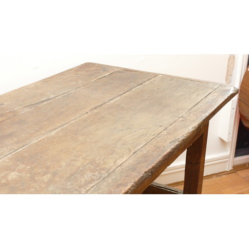 475 - A 17th century provincial oak refectory table, the three plank  top with cleated ends, raised on cha... 