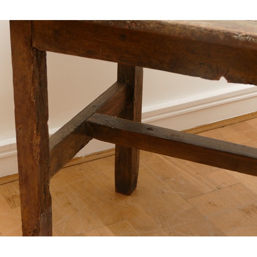 475 - A 17th century provincial oak refectory table, the three plank  top with cleated ends, raised on cha... 