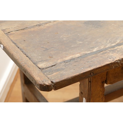 475 - A 17th century provincial oak refectory table, the three plank  top with cleated ends, raised on cha... 