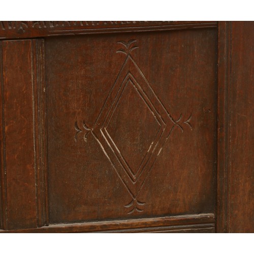 476 - A 17th century oak coffer, the hinged three panel top, above a guilloche frieze and two lozenge carv... 