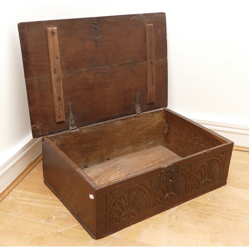 477 - A 17th century oak bible box, with iron mounts and lock, the front panel carved with foliate and lun... 