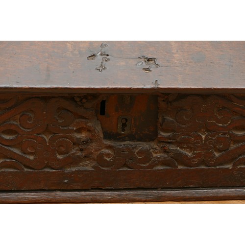 478 - A late 17th century oak bible box, the carved hinged top above carved foliate sides, with iron lock ... 