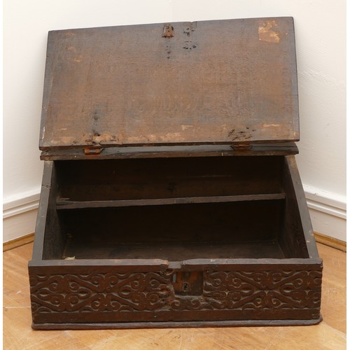 478 - A late 17th century oak bible box, the carved hinged top above carved foliate sides, with iron lock ... 