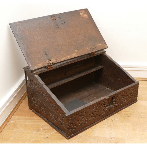 478 - A late 17th century oak bible box, the carved hinged top above carved foliate sides, with iron lock ... 