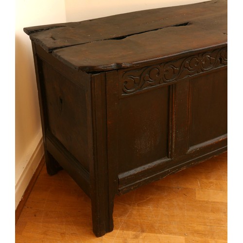 479 - A 17th century oak coffer, with plank top and loop hinges, three blind carved and moulded panels, ra... 