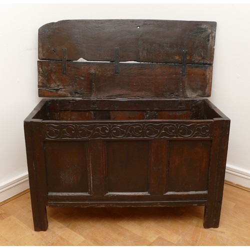 479 - A 17th century oak coffer, with plank top and loop hinges, three blind carved and moulded panels, ra... 