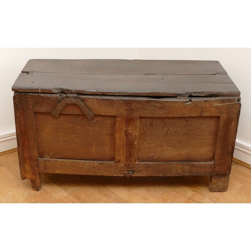 482 - An 18th century oak coffer, having two plank hinged top over three panel front, with arcaded frieze ... 